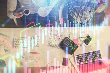 Double exposure of man and woman working together and financial chart hologram drawing. market analysis concept. Computer background. Top View.