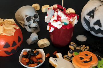 Halloween party table with treats and scary decoration