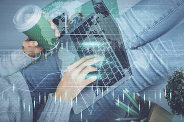 Double exposure of woman hands typing on computer and forex chart hologram drawing. Stock market invest concept.