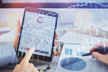 Multi exposure of man's hands holding and using a phone and financial chart drawing. Market analysis concept.