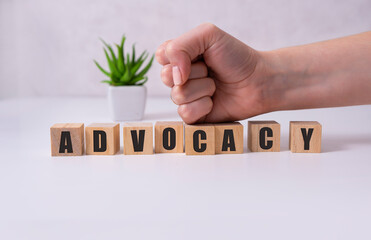 ADVOCACY word made with building blocks with hand.