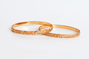 Gold bangle isolated on white background. Celebrity lifestyle accessories. Crazy rich lifestyle. Model Accessories
