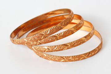 Gold bangle isolated on white background. Celebrity lifestyle accessories. Crazy rich lifestyle. Model Accessories
