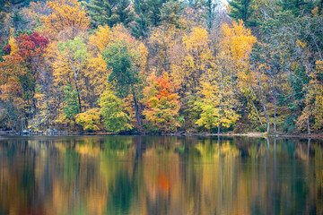 The beauty of autumn colors in the forests reflects off a lake in upstate New York.