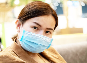 Businesswomen manager company office asian is looking at camera wear mask blue for protect sick ill flu covid-19 corona virus disease danger health care medical 