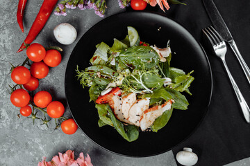 smoked chicken salad on a black plate