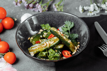 Salad of broken cucumbers with sesame seeds, sugar, red and black pepper, olive oil