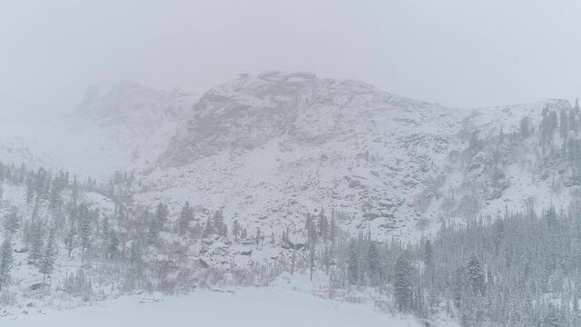 Beautiful Mountain Landscape View of White Puffy Snow Covered Raduzhnoe Lake during winter day. Located Nature Park Ergaki, Krasnoyarskiy krai, Russia. High quality 4k footage