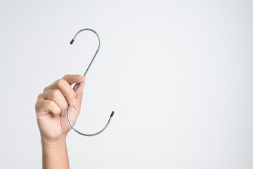 Hand holding stainless steel s curve hook for hanging