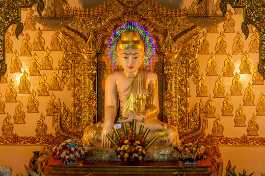 The pure white marble statue of Buddha outside of Myanmar temple in Singapore. Maha Sasana Ramsi Burmese Temple is a religious landmark in Singapore