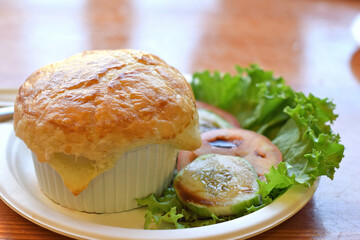 Chicken pot pie and some vegetables on the table