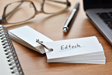 The words "Edtech" written in a word book. Close-up.It was coined by combining the words "Education" and "Technology".