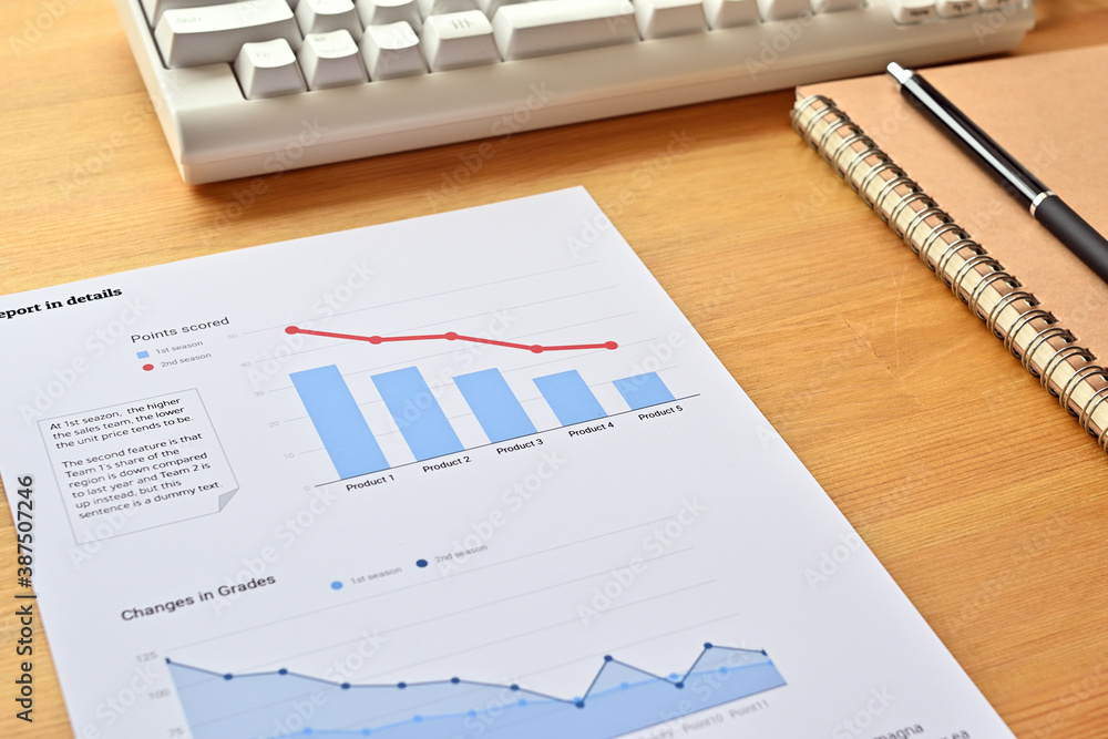 Aufkleber there's a piece of paper with a downward trending line and a bar chart on it, along with a white key