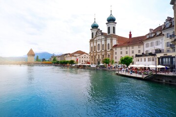 Fototapeta na wymiar Lucerne, Switzerland - June 15, 2019 : City centre of old town Lucerne with restaurant, crowd and famous chapel bridge with clear blue crystal river of Lucerne, Vierwaldstattersee, Switzerland