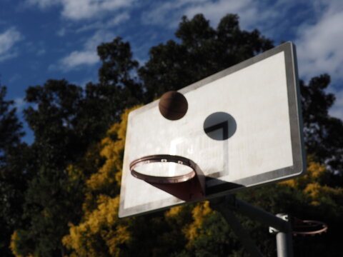 Basketball about to go through ring