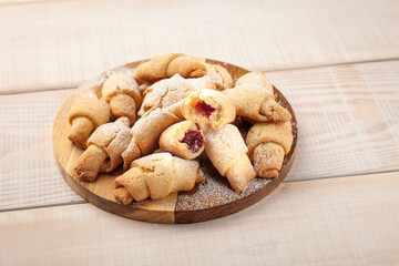 Tasty shortbread cookie with jam in wooden bowl