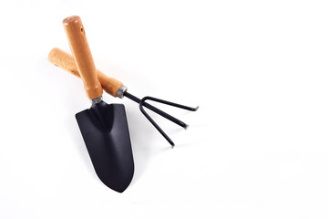 Tools garden shovel and rake isolated on white