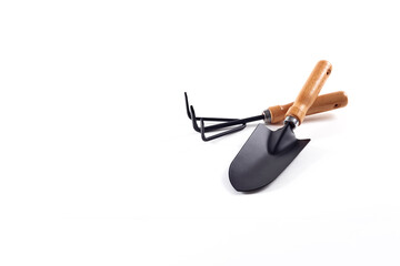 Tools garden shovel and rake isolated on white