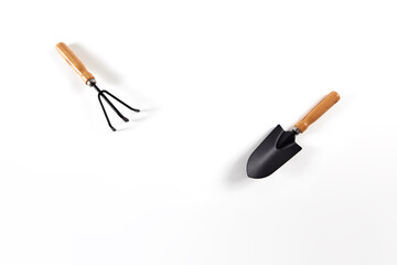 Tools garden shovel and rake isolated on white