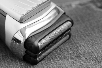 Electric shaver on a jeans, black and white image