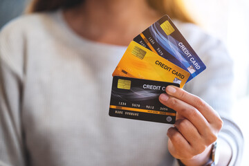 Closeup image of a woman holding and showing credit cards