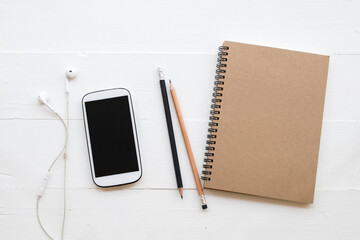 mobile phone ,notebook ,pencil of student writing note for study decoration flat lay style on background white wooden