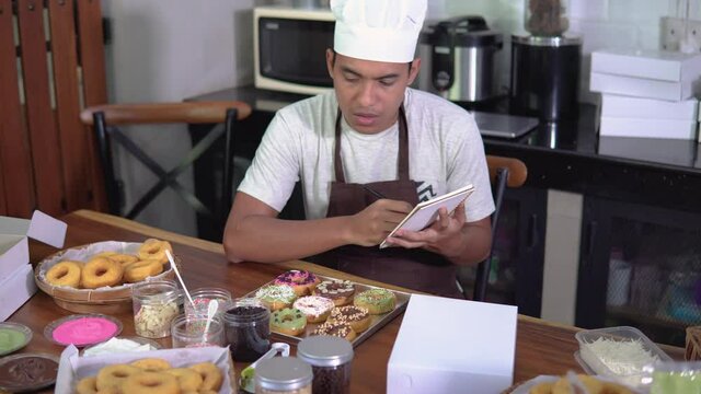 stressed business owner taking order from customer. small food baker at his kitchen
