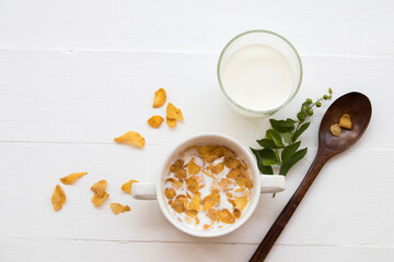 mix corn flakes, milk healthy foods for children eats and healthy drinks fresh milks in breakfast decoration flat lay style on background wooden white