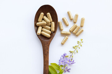 tablets capsules extract from herbal health care for woman and purple flowers decoration flat lay style on background white 