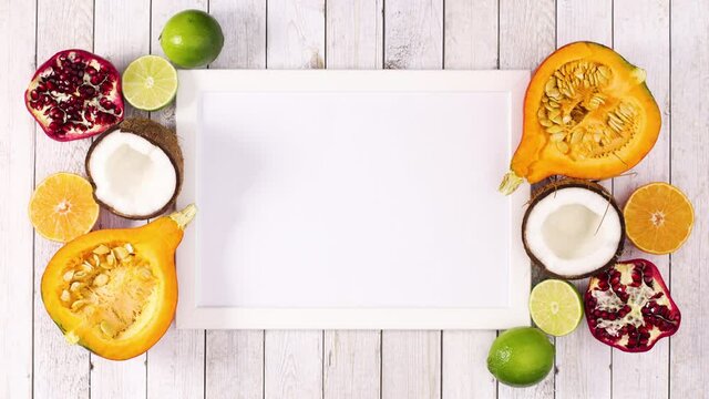 Frame for text and fruits around frame appear on wooden theme. Stop motion 