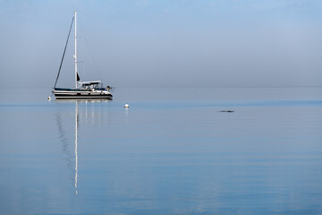 Fototapeta premium Anchored sailboat in Watmough Bay on Lopez Island, Washington, USA