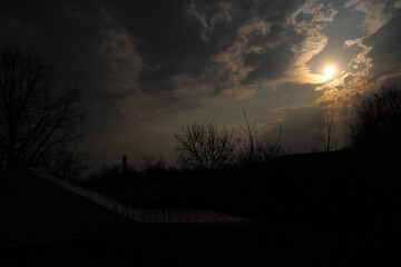 the sun breaks through the clouds over the village