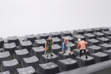 mini people cleaning the keyboard Or calculator
