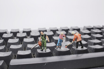 mini people cleaning the keyboard Or calculator