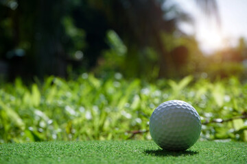 Golf balls on the golf course with golf clubs ready for golf in the first short. In the morning, with the beautiful sunlight.Sports that people around the world play in the holidays