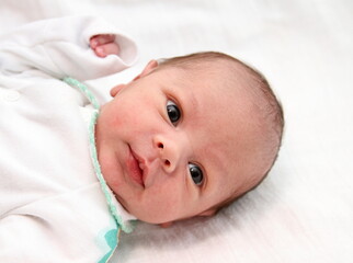 little baby looking after having a good night sleep on white background