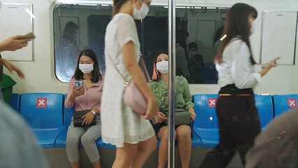 Crowd of people wearing face mask on a crowded public subway train travel . Coronavirus disease or...
