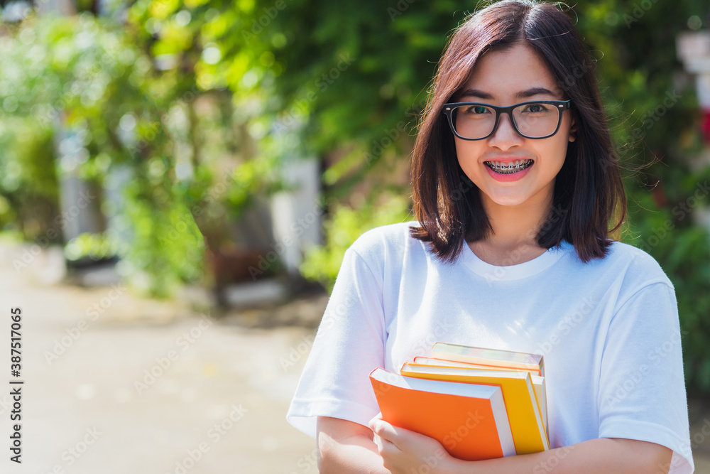 Wall mural portrait of asian teen beautiful young woman wear eyeglasses smile have dental braces on teeth laugh