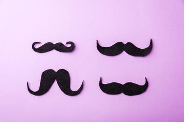 Black mustache paper, studio shot isolated on purple background, Prostate cancer awareness month, Fathers day, minimal November moustache concept