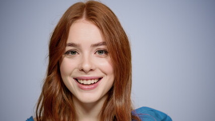 Fototapeta premium Portrait of romantic girl posing indoors. Redhead young woman sending air kisses