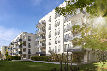 Cityscape with modern residential area, new apartment buildings and green courtyard with pedestrian...