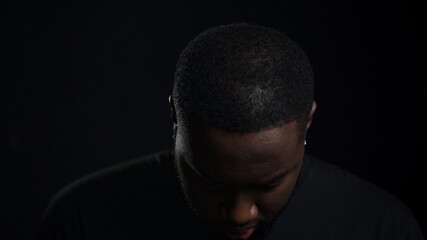 Handsome african american guy staring at lense. Guy looking at camera in studio