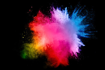Abstract multi color powder explosion on black background. Freeze motion of color dust particles...