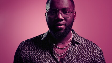 African american man smiling at camera in studio. Disco guy posing on camera