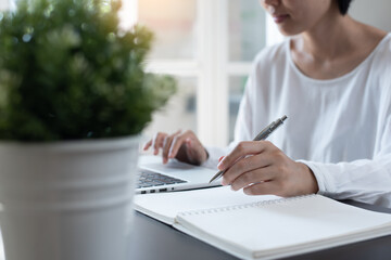 Female student studying online class via laptop computer at home