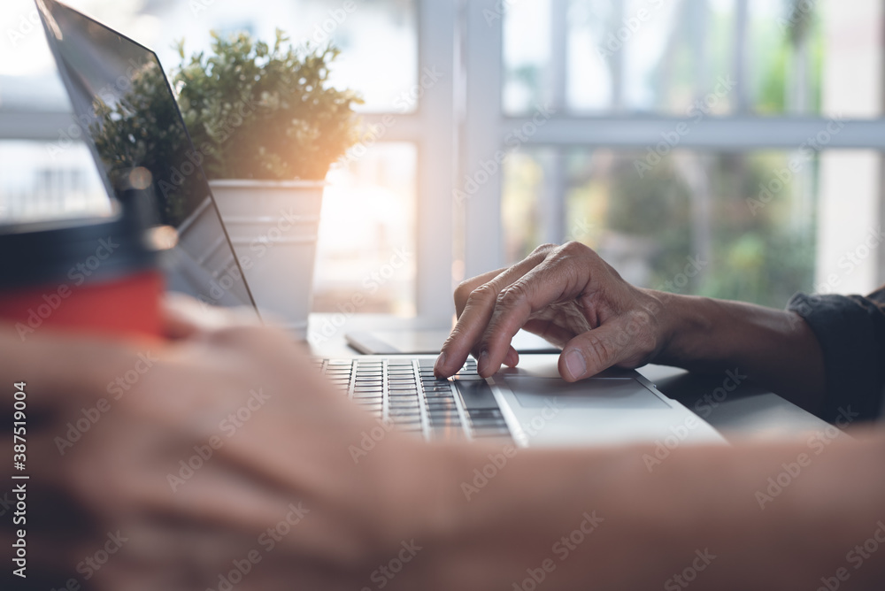 Poster man surfing the internet on laptop computer during working from home