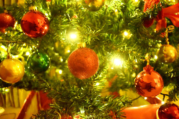 Fototapeta na wymiar Decorations on Christmas tree with shiny glare