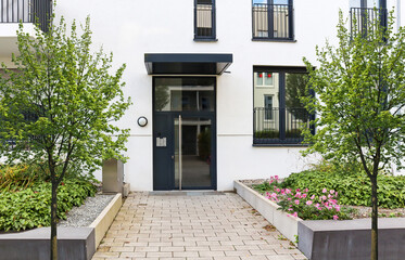 View to entrance door of a modern residential building with new apartments in the city - 387519811
