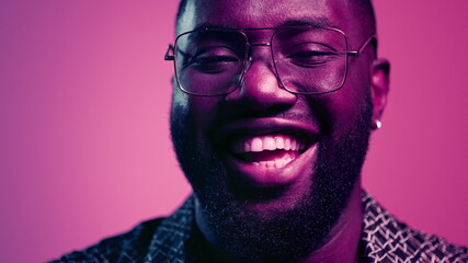 African american man laughing in studio. Natural male person smiling indoors