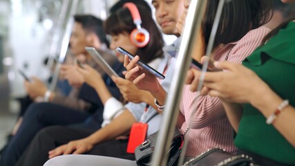 Young people using mobile phone in public underground train . Urban city lifestyle and commuting in...